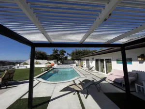 Elite L.A. Patios - The Truth About Patio Cover Materials: Why 4K Aluminum Reigns Supreme - white louvered pergola over pool