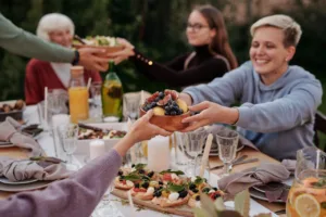 Elite L.A. Patios - Ultimate Guide to Hosting an Outdoor Dinner Party in LA - Woman in Hoodie Jacket Holding a Bowl of Fruits