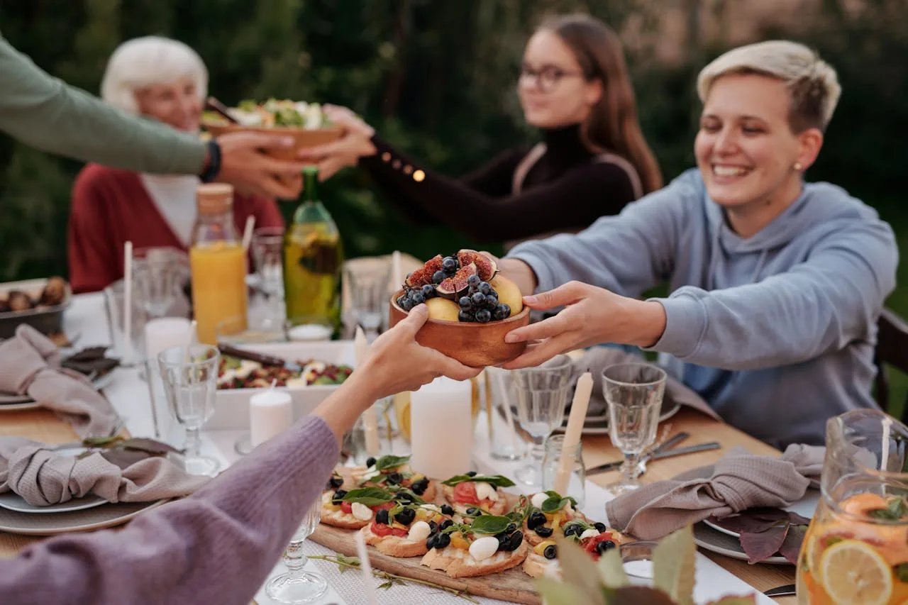 Elite L.A. Patios - Ultimate Guide to Hosting an Outdoor Dinner Party in LA - Woman in Hoodie Jacket Holding a Bowl of Fruits